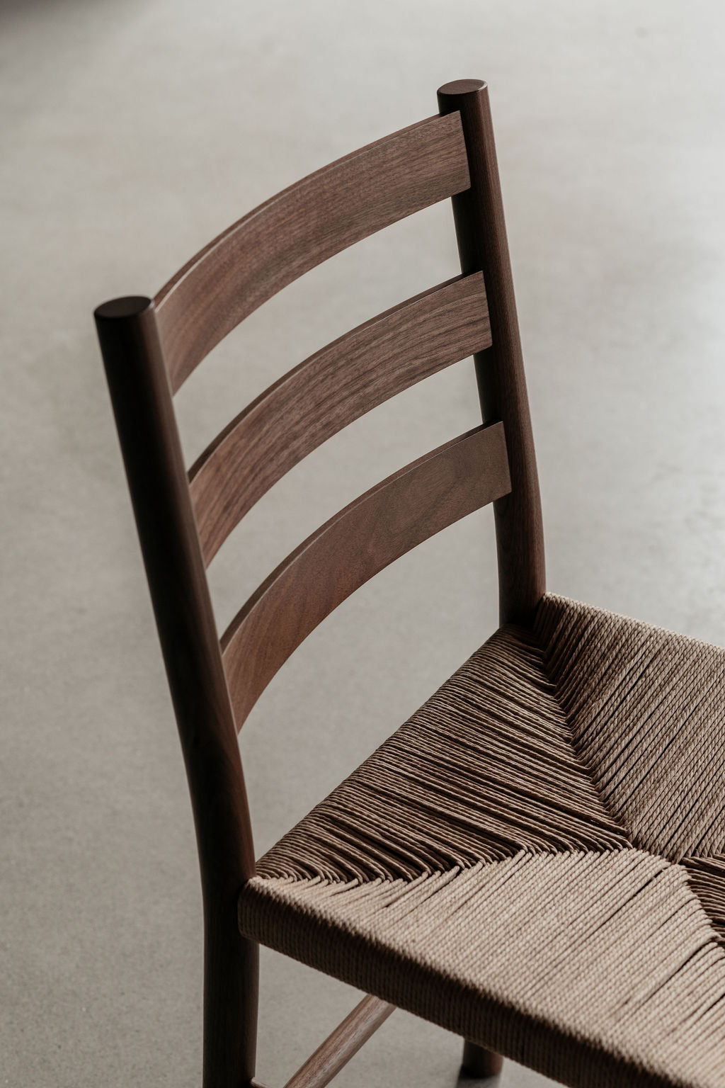 Moody lighting on the Knox ladder back chair with woven danish cord seat in walnut