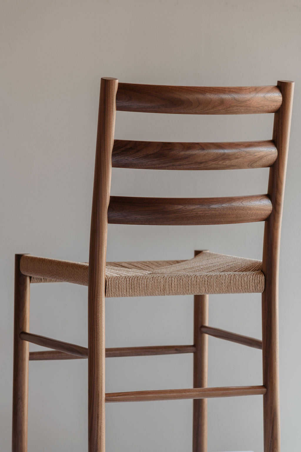 Knox ladder back chair with woven danish cord seat in walnut wood photographed from the back
