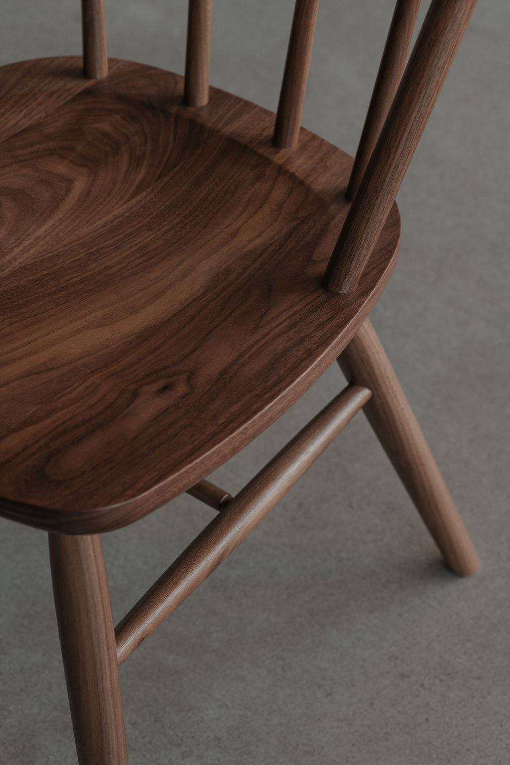 Seat and spindle details on the walnut wood Hudson bowback dining chair from Justines Home