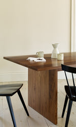 Casual setting at the dining table with black windsor style chairs, walnut table, coffee mugs and chocolate