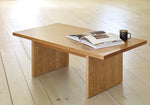 Casual wood coffee table with book and coffee on wood pine floors in bright room