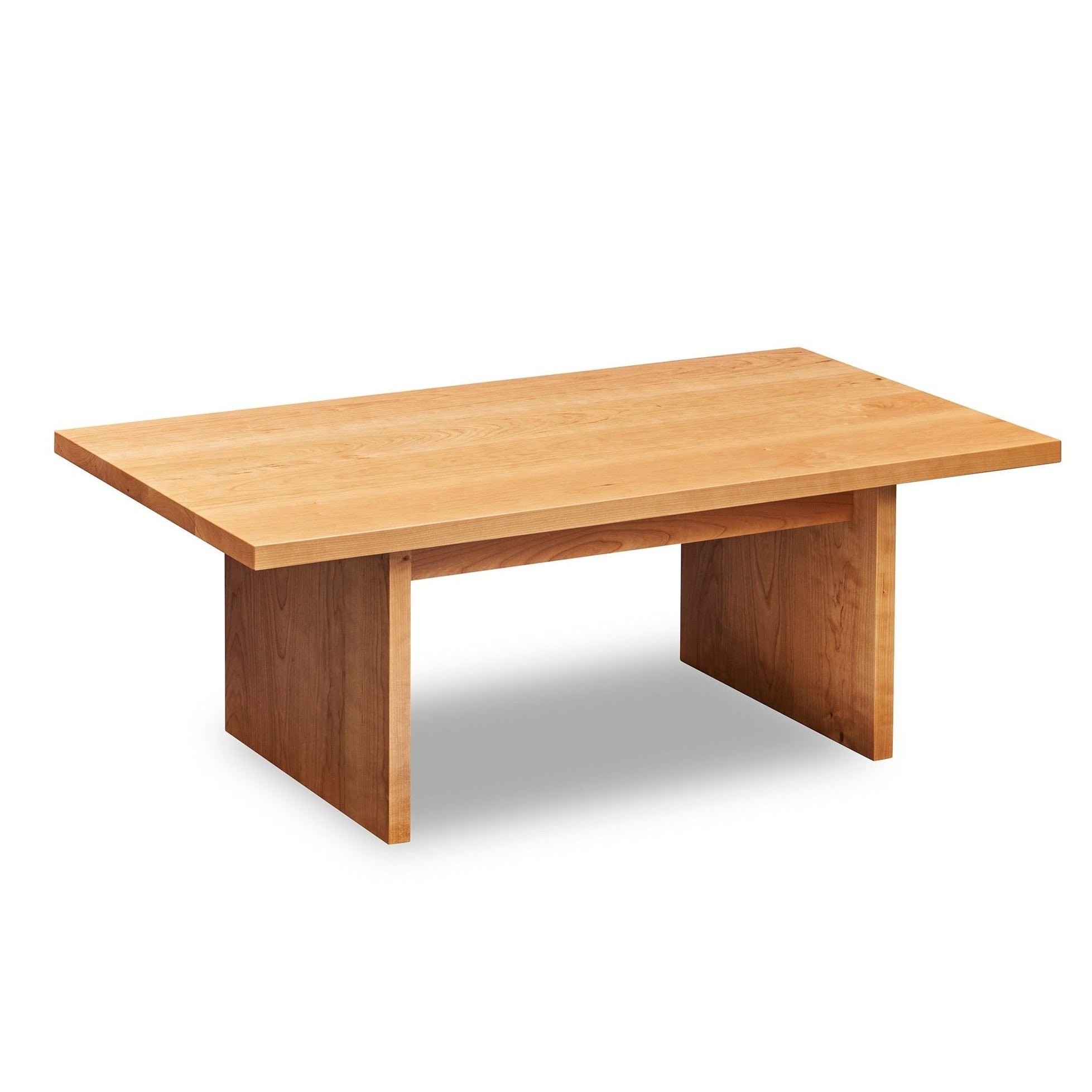 Modern handcrafted wood coffee table with trestle panel style legs in solid cherry