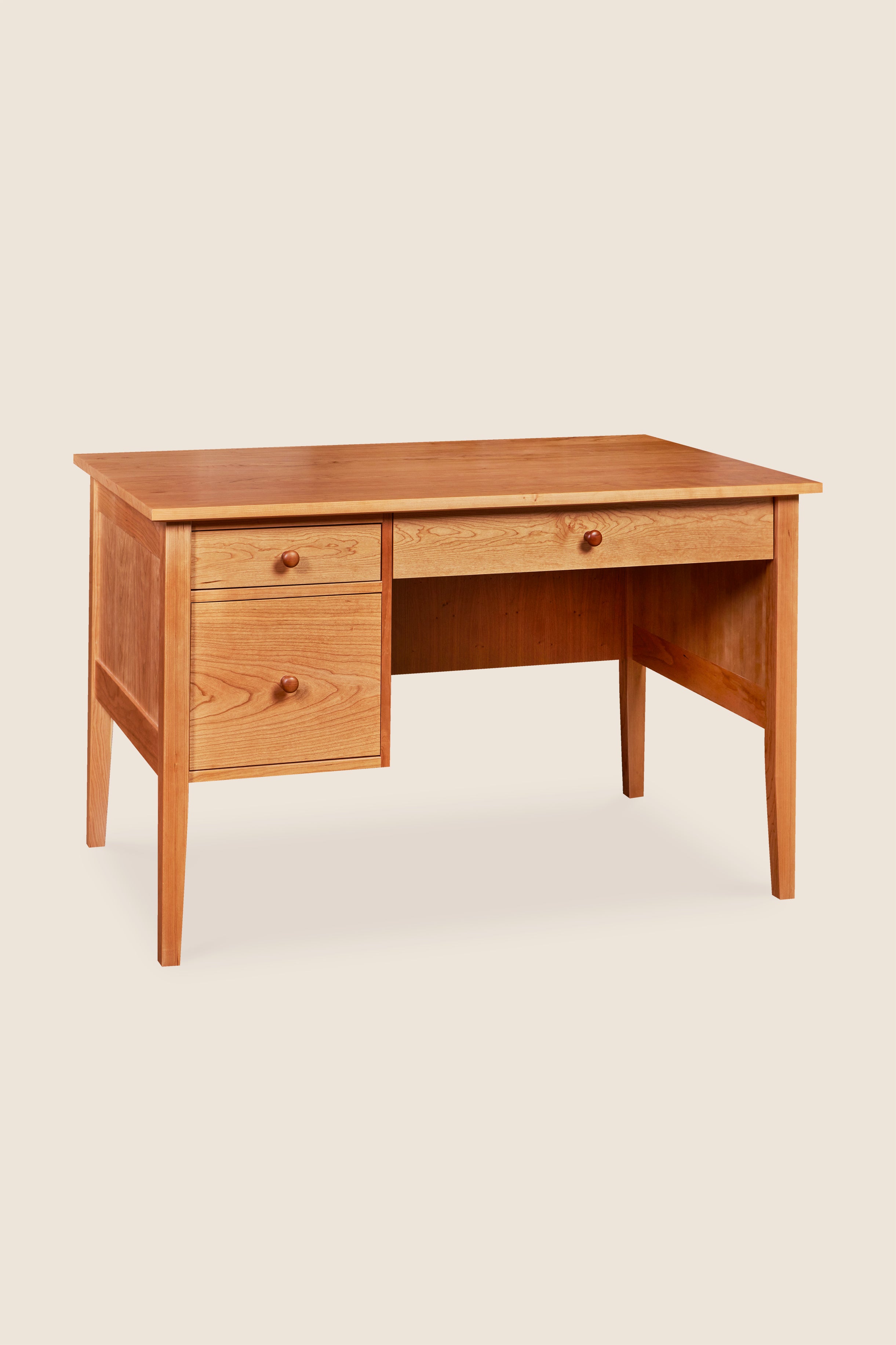 Wooden desk with two drawers on a beige background