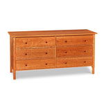 Modern interpretation of a classic Shaker style dresser with six drawers and rounded legs, in solid cherry wood