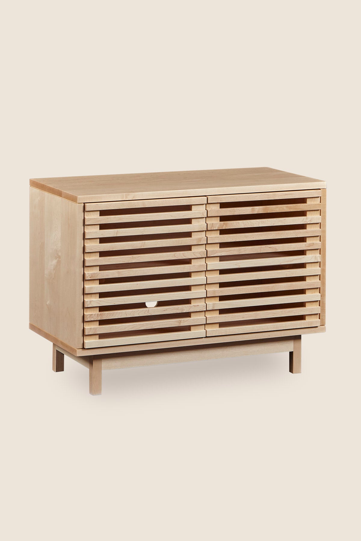 Modern slatted media stand from Mazhil & Co. in small size and maple wood