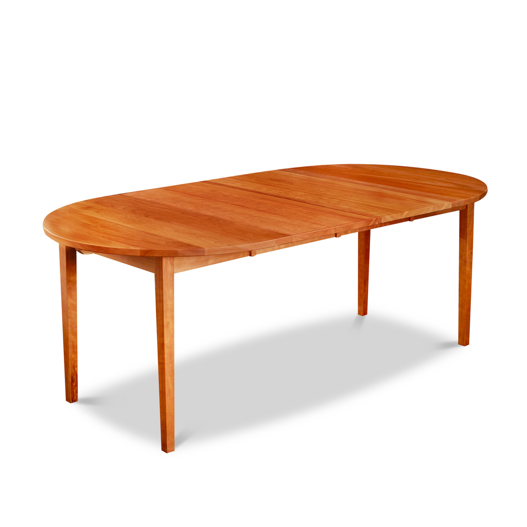 Solid cherry wood extension table with tapered Shaker legs and oval top from Maine's Chilton Furniture Co.
