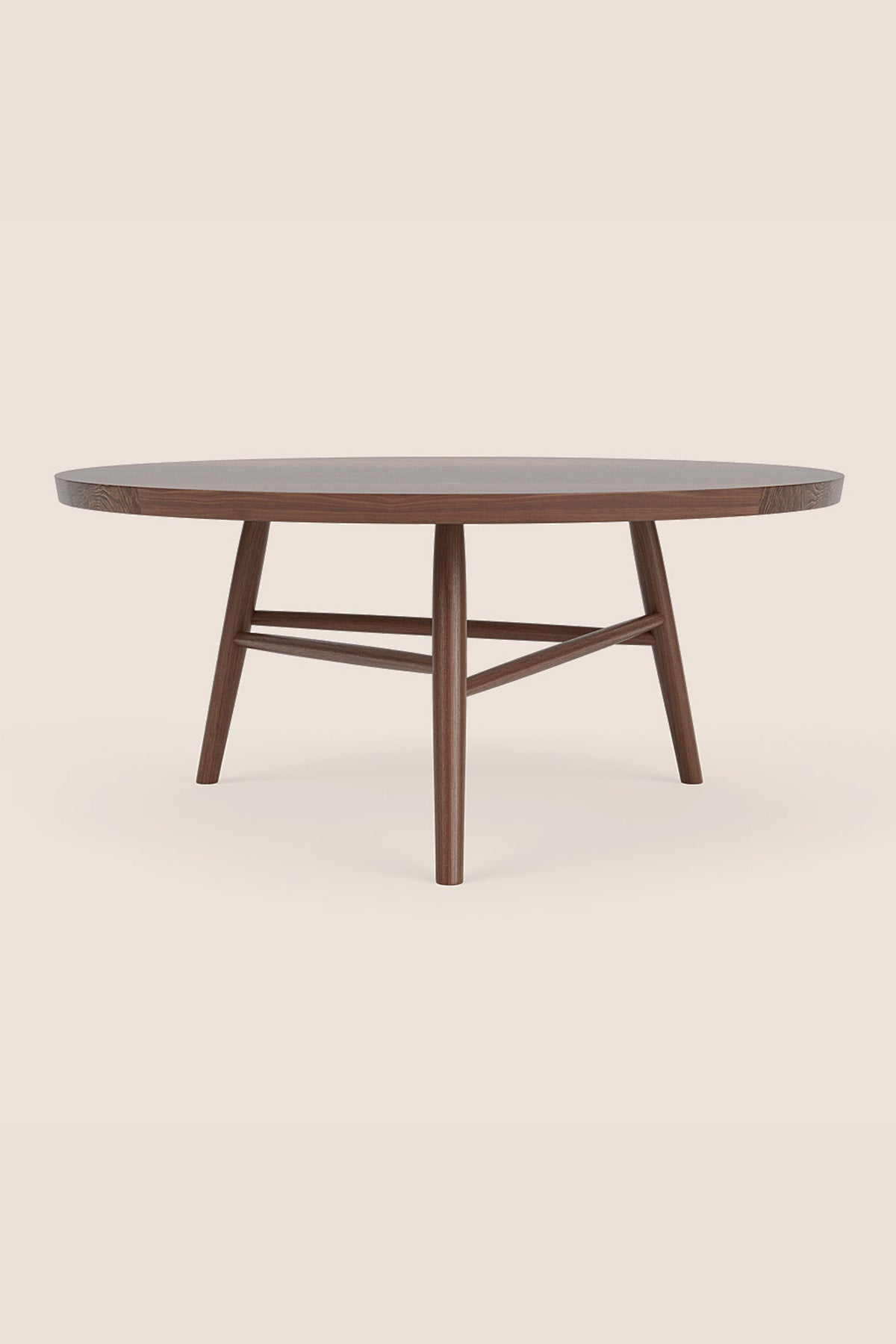 Round wooden Hudson Coffee Table in walnut with three legs on beige background