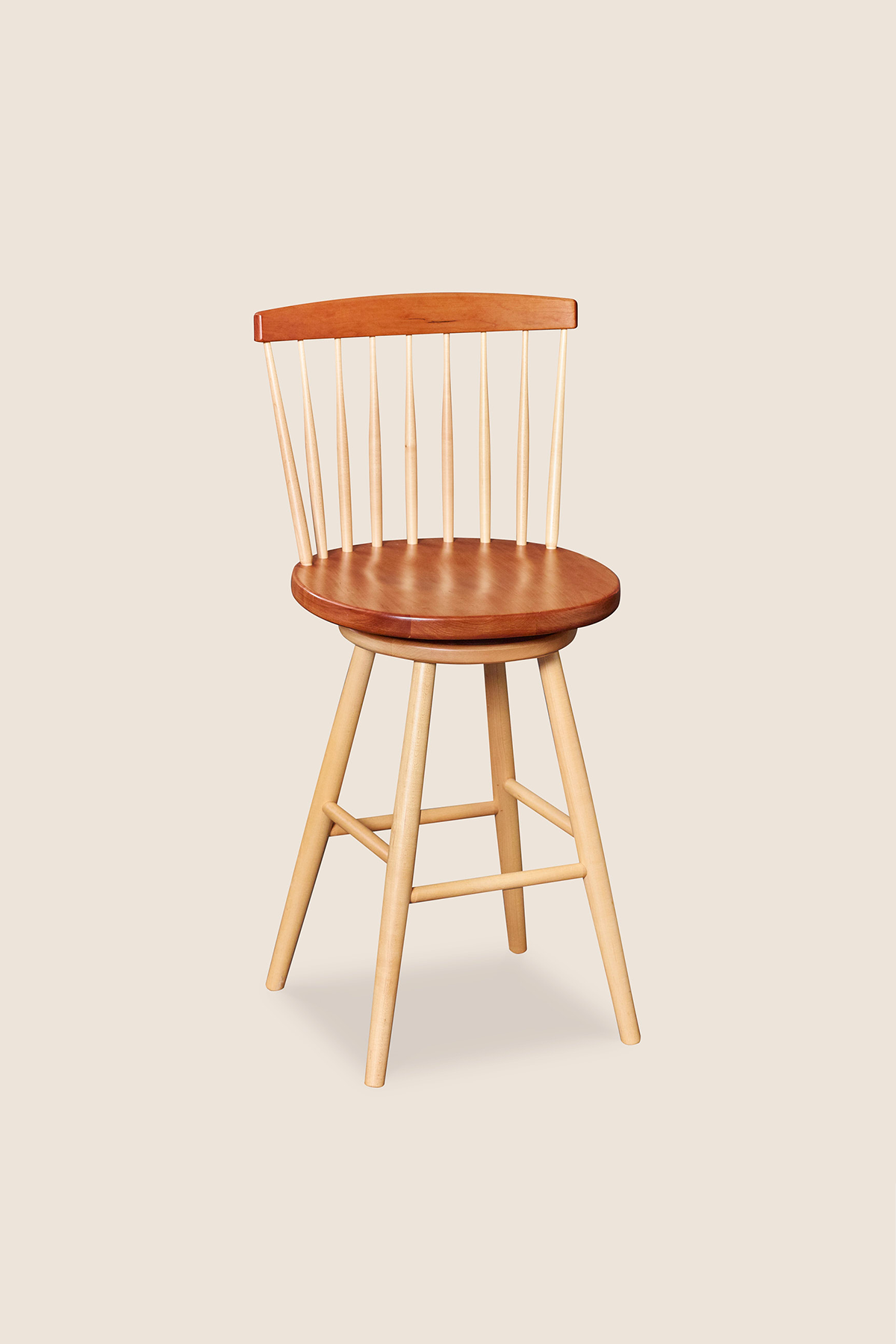 Cherry and maple swivel counter stool with spindle back, from Maine's Chilton Furniture Co.