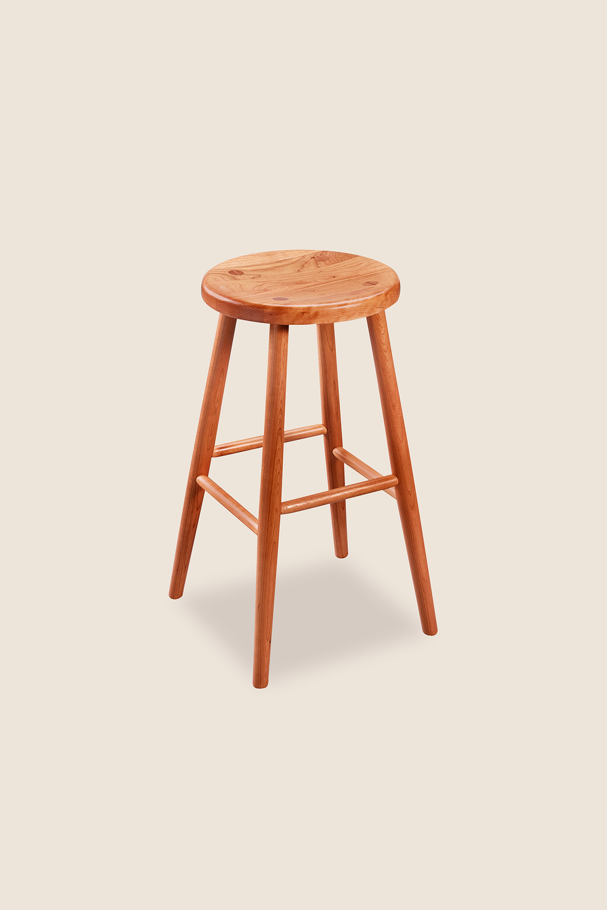 Simple round solid cherry wood stool, from Arkansas's Mazhil & Co. Co.
