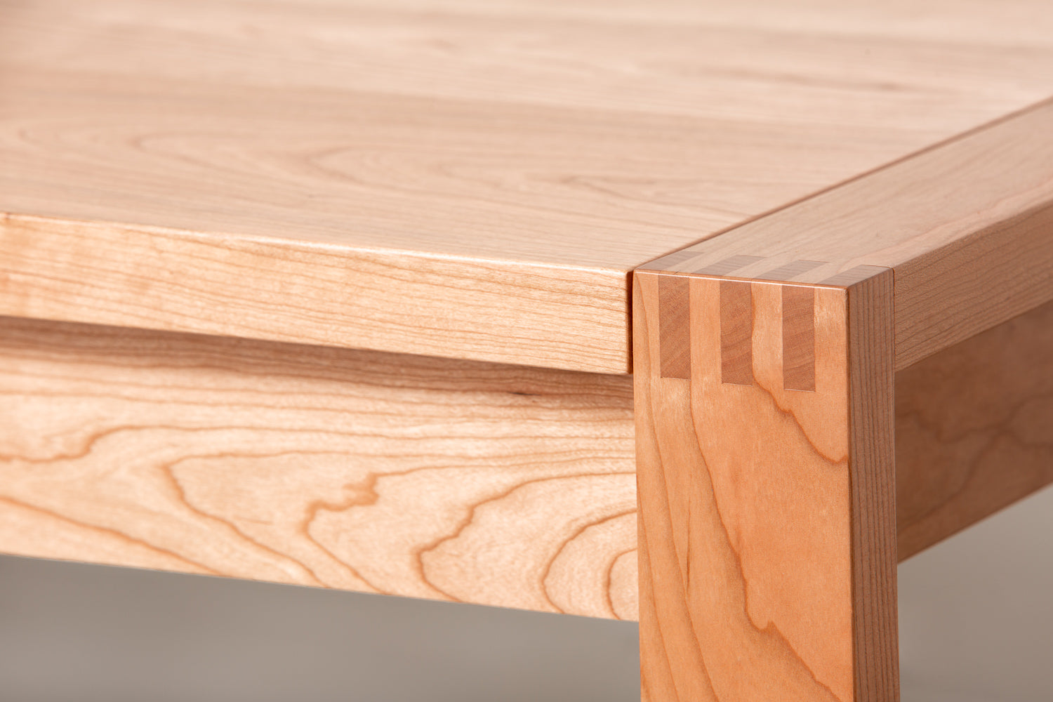 Close up of finger joints on a modern wood Parsons table from Chilton Furniture.