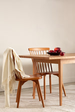 Solid wood Shaker dining table with spindle chairs.