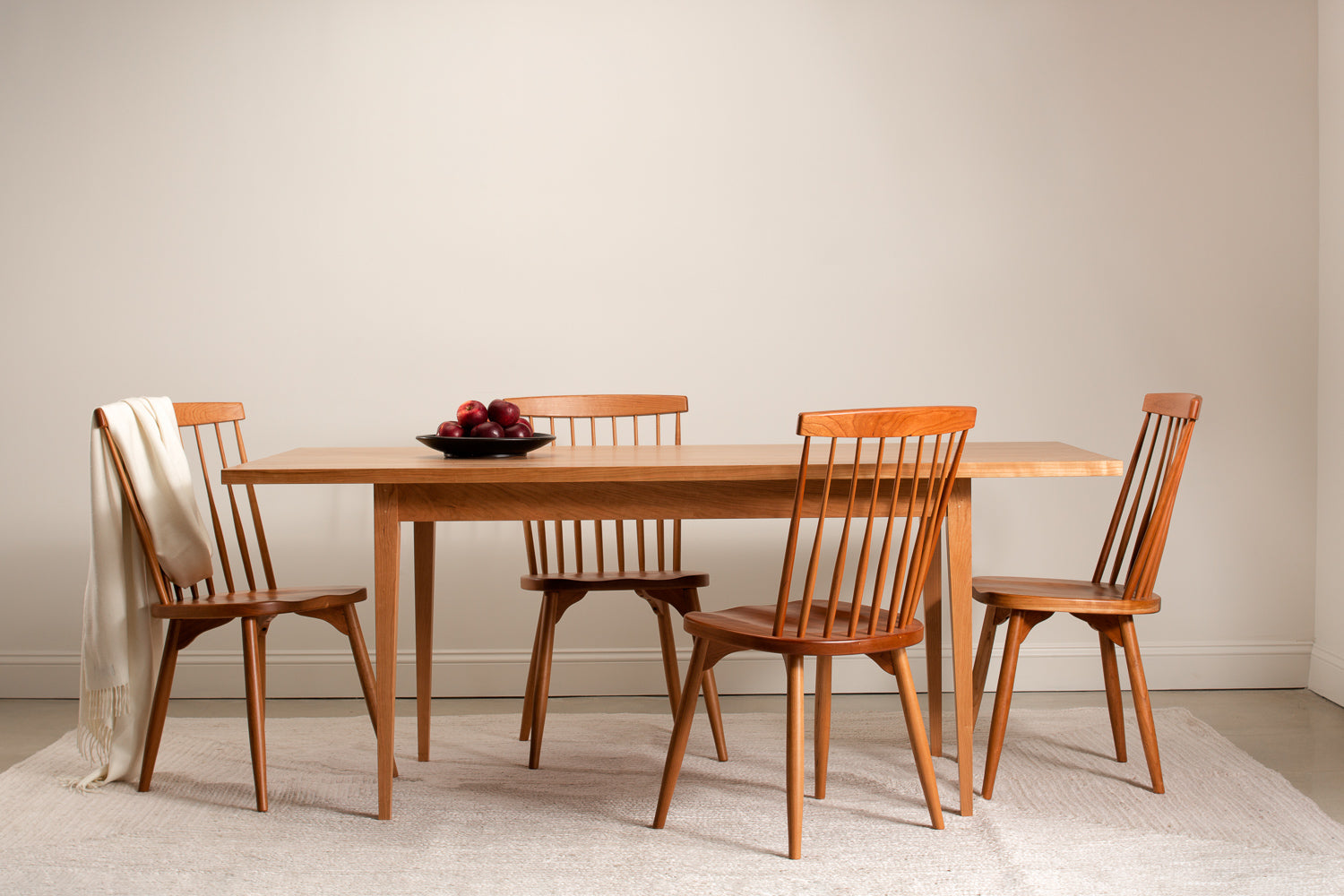 Solid wood Shaker dining table with spindle chairs.