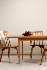 Solid wood Shaker dining table with spindle chairs.