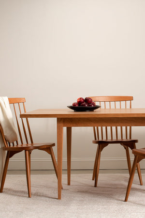 Solid wood Shaker dining table with spindle chairs.