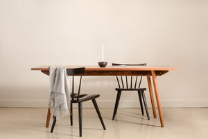 Scandinavian inspired walnut dining table with black wood chairs from Chilton Furniture.