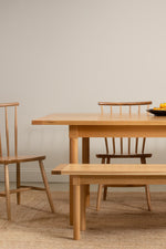 Revelry dining set from Chilton Furniture shown in white oak solid wood with fruit on table