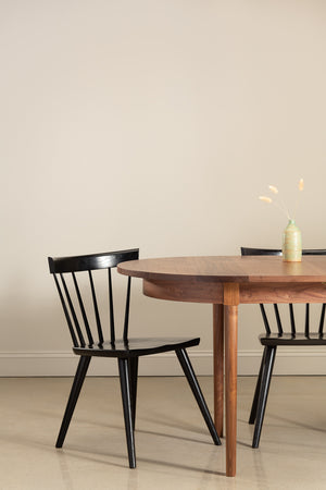 Walnut wood Highland dining table with black chairs