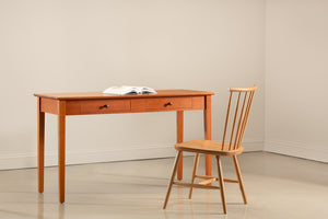 Shaker writing desk in cherry with oak chair and open book against blank wall