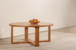 Round Lokie coffee table shown in cherry with blow of fruit