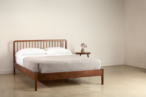 Modern Spindle bed in walnut wood with three legged Mysa Nightstand