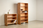 Lubec Short and Tall Selves in cherry wood styled with books, bowls, and pottery