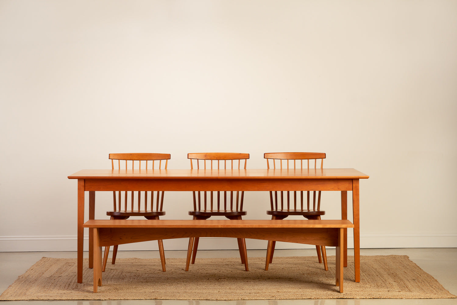 Chilton Furniture's Shaker Dining Table paired with the Shaker Bench and Chilton Spindle Chairs in solid cherry wood