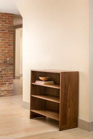 Walnut Lubec Shelf styled with books and wooden bowl