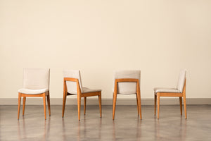 Four cherry Metro Chairs with grey fabric cushions showing the chair at four different angles