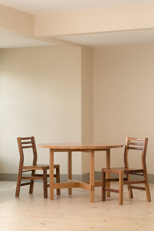 Walnut Dockside Chairs paired with cherry Union Round Dining Table from Chilton Furniture