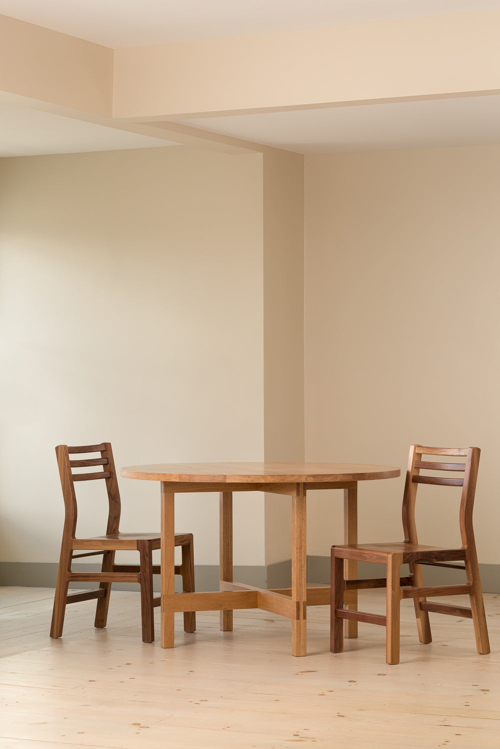 Walnut Dockside Chairs paired with cherry Union Round Dining Table from Chilton Furniture