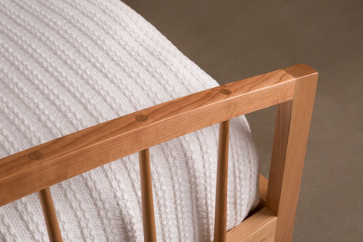 Mortise and tenon joinery on  arched footboard of Burnette Spindle Bed