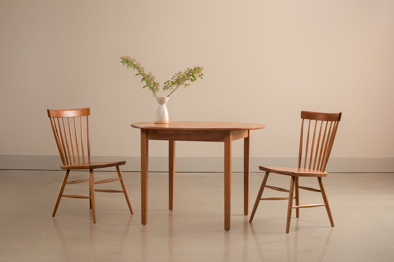 Harvest chairs and Shaker Round Dining Table in cherry with large leafy centerpiece