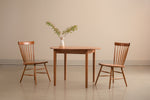 Harvest chairs and Shaker Round Dining Table in cherry with large leafy centerpiece