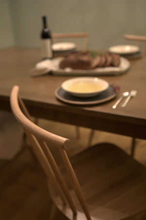 Thanksgiving dinner table setting with white oak spindle Concord chairs