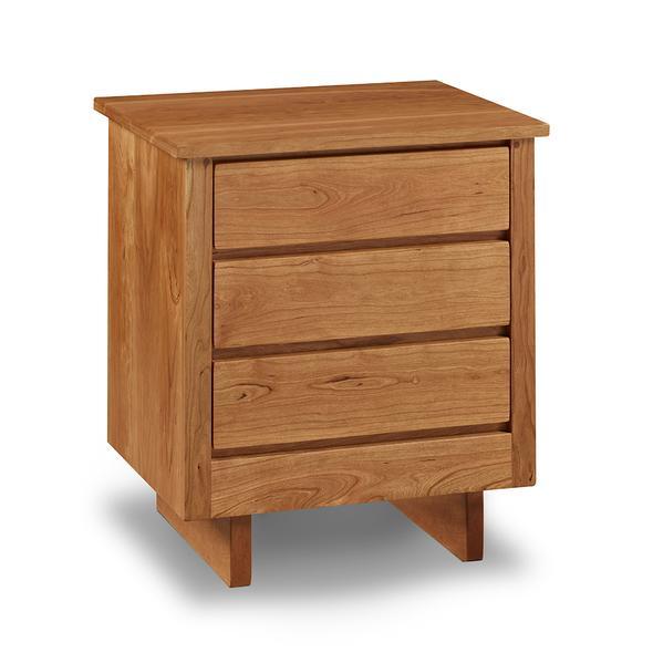 Chilton Furniture's Acadia collection three drawer cherry bedroom nightstand with under drawer pulls and panel base
