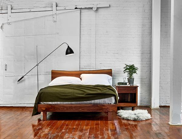 Modern industrial bedroom with white brick walls and walnut Acadia nightstand and live edge bed