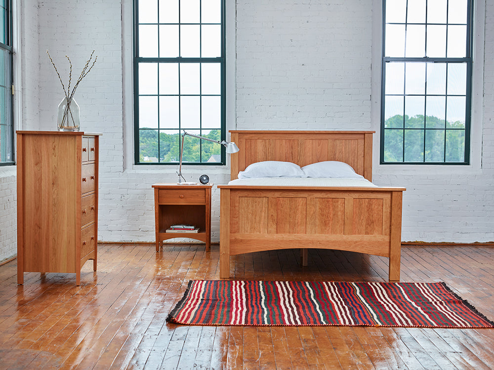 Modern warehouse bedroom styled with Chilton Furniture's cherry wood Bethel bedroom collection