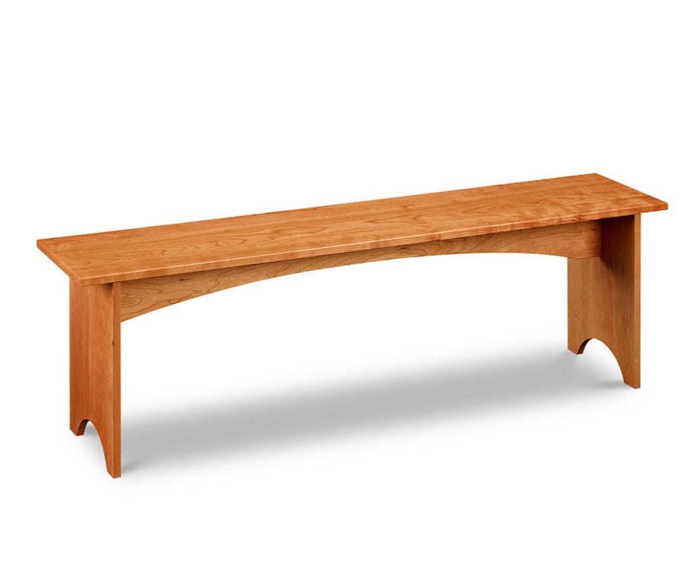 Simple cherry wood bench, built in the Shaker style with half-moon cutout on both leg boards from Maine's Chilton Furniture Co. 