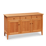 Wide buffet with three drawers above three doors, built in cherry wood with clean tapered legs