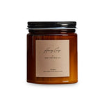 Honey Crisp scented candle in amber jar with black lid