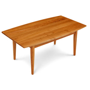 Shaker style cherry wood coffee table, with a curved "boat shaped" side edge