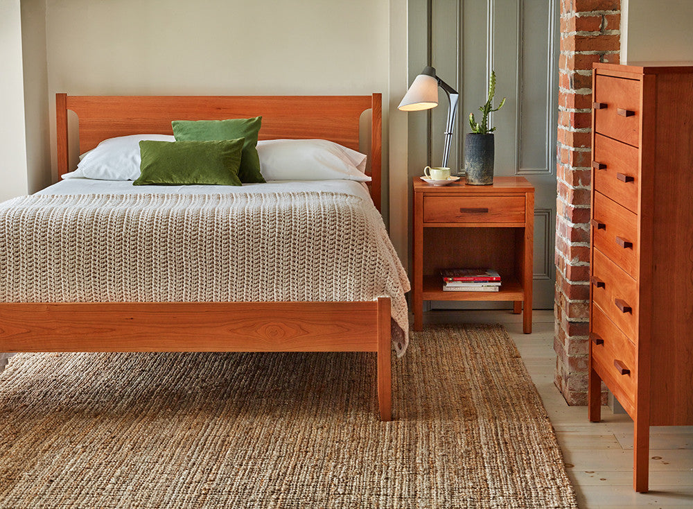 Bedroom with Shaker style solid cherry wood bed with Scandinavian style dresser and nightstand from Maine's Chilton Furniture Co.