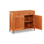 Shaker style storage buffet with two doors and two drawers built of cherry wood; one door is open to show shelf and storage space inside