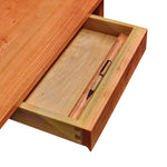 Open drawer of cherry Acadia writing desk showing dovetail joinery and pencil ledge