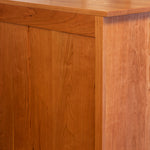 Finished solid cherry wood back of Acadia bedroom storage dresser