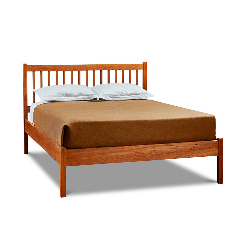Modern solid cherry wood bed with square dowel spindles on headboard, from Maine's Chilton Furniture Co. 