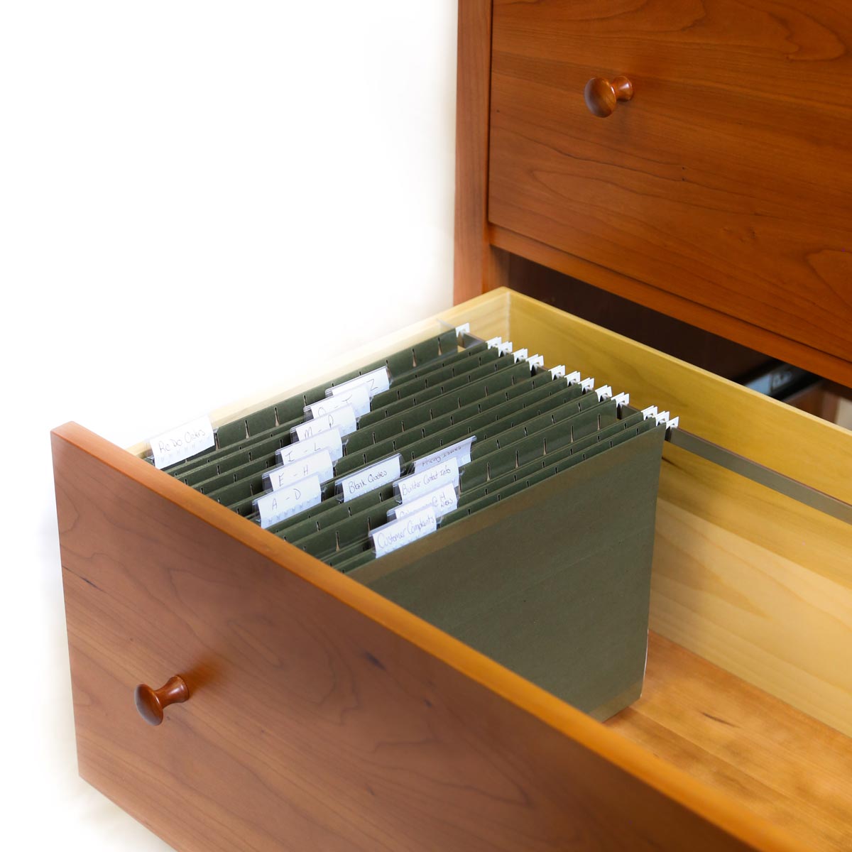 Open drawer of large Shaker file office storage with green files inside