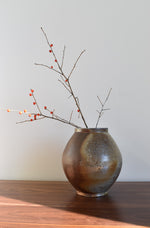 Round dark speckled pottery vase