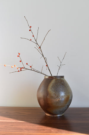 Round dark speckled pottery vase