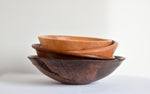 Stack of wooden walnut, cherry, oak and maple bowls